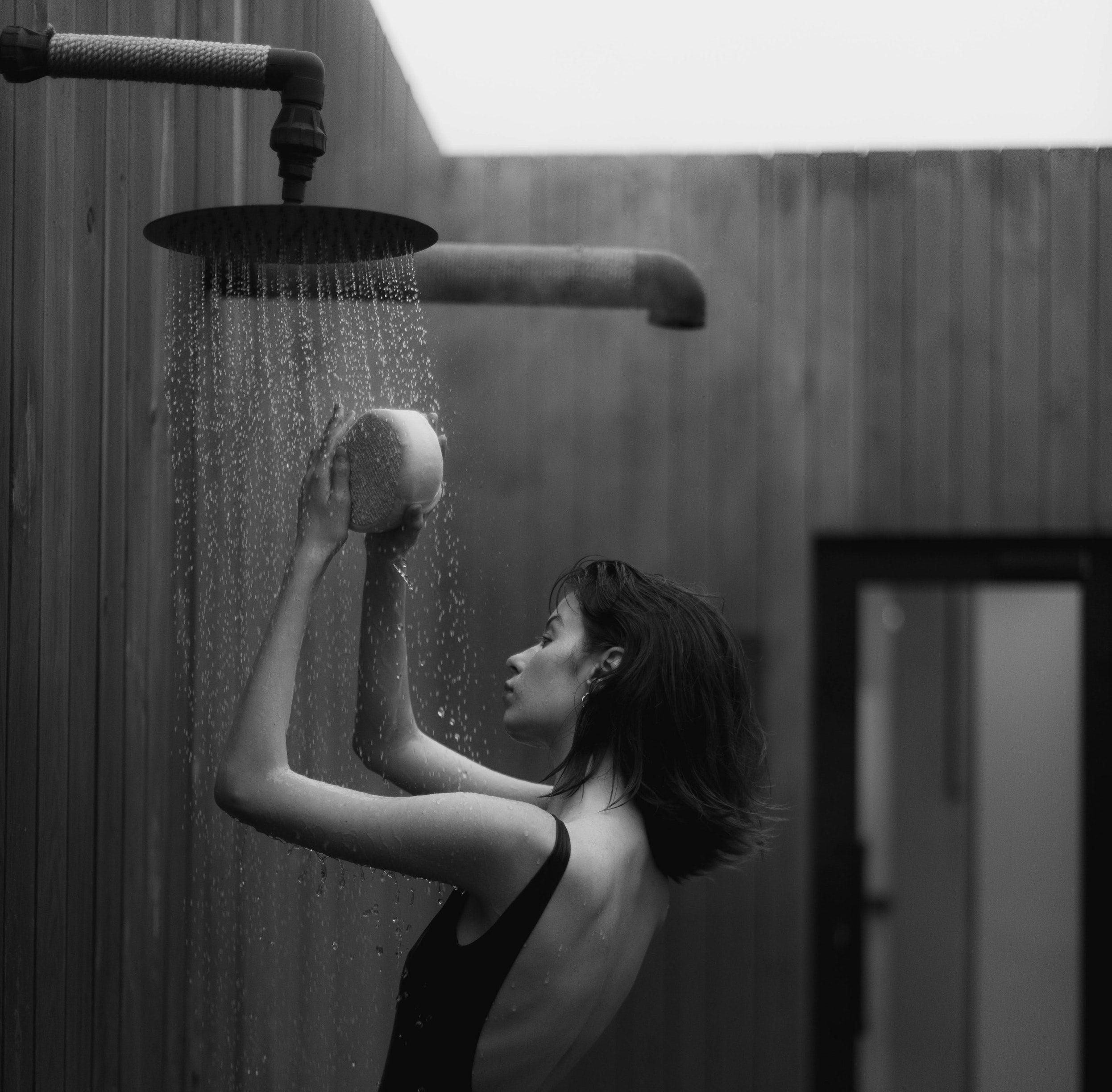 Women in bathing suit showering